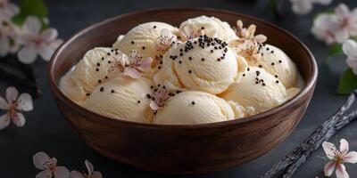 Vanilla ice cream served in a wooden bowl with blossoms and chocolate sprinkles on a dark background photo