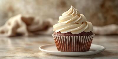 Delicious chocolate cupcake with creamy frosting on a marble surface photo