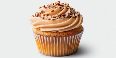 Delicious cupcake with caramel frosting and chopped nuts on top, suitable for any dessert lover's delight photo