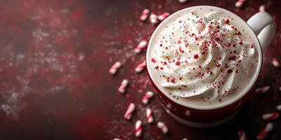 Rich hot chocolate topped with whipped cream and crushed candy canes in a cozy winter setting photo
