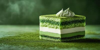 Delicious matcha cake with layers of green tea and cream displayed on a textured surface photo