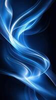Abstract blue light waves create a mesmerizing flow in a dark space, emphasizing movement and energy photo