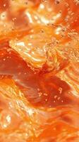 Bright orange liquid creates dynamic splash patterns in close-up during sunny daylight photo