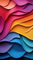 Colorful layered paper waves creating a dynamic visual texture in brilliant hues of red, pink, yellow, blue, and green photo