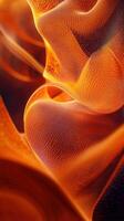 Flowing orange textures create a mesmerizing visual in a natural setting during soft lighting conditions photo