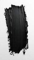 Black paint applied in abstract strokes, creating a textured and artistic finish on a white background photo
