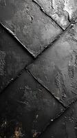 Textured black surface with layered panels reflecting light at an artistic angle photo