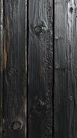 Textured black wooden planks showing a rustic surface with unique patterns and a dark finish photo
