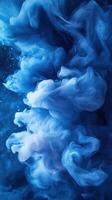 Swirling blue clouds create an ethereal underwater atmosphere in a vibrant abstract setting photo