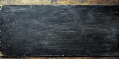 Black chalkboard on wooden surface ready for writing educational content in classroom or cafe environment photo