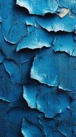 Peeling blue paint on a textured wall creates a captivating display of layered color and decay photo