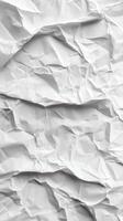 Crumpled white paper with creases and folds creates a textured background for creative projects and design work photo