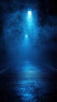 Mysterious foggy alley illuminated by blue lights in the evening photo