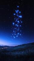 Bright constellations illuminate the night sky over a serene landscape at dusk photo