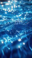 Rippling clear blue water reflecting light with splashes and bubbles during a bright daytime setting photo