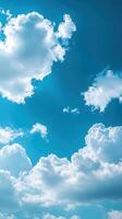 Bright clouds float in a clear blue sky during midday, creating a serene and peaceful atmosphere for all photo
