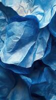 Blue crumpled paper texture creates a vibrant background for creative design projects and artistic expressions photo