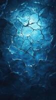 Frozen ice texture creating a striking blue background with intricate patterns illuminated by soft light photo
