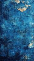 Distressed blue wall with peeling paint showcasing texture and depth in the light photo