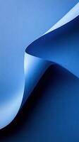 Fluid blue paper curves creating a harmonious design against a dark blue backdrop photo