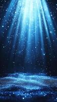 Dramatic light rays shine through shimmering blue particles in a dark setting photo