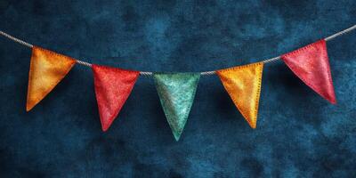 Colorful fabric bunting decorations hanging against a blue textured backdrop for a festive atmosphere photo