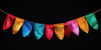 Colorful papel picado banners hanging against a dark background for festive occasions photo