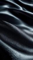 Close-up view of luxurious dark fabric showcasing intricate texture and smooth waves photo