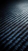 Dark textured surface of woven material captures subtle light patterns during an artistic display of shadows and depth photo
