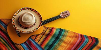 Decorative sombrero and guitar surrounded by colorful fabric create a vibrant cultural display photo
