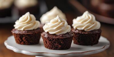Delicious chocolate cupcakes topped with fluffy cream frosting on a vintage white plate photo