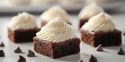 Delicious chocolate brownies topped with creamy frosting on a white dessert table during a baking event photo