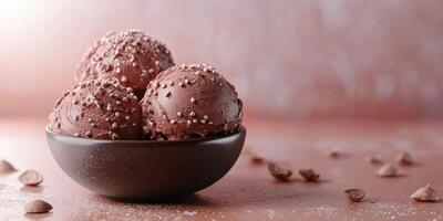 Rich chocolate ice cream scoops with sprinkles served in a bowl on a textured surface photo