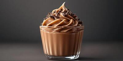 Delicious chocolate mousse topped with chocolate shavings in a clear glass cup photo
