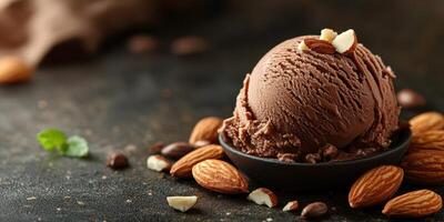 Chocolate ice cream scoop served with almonds and mint on a dark background featuring a rustic style photo