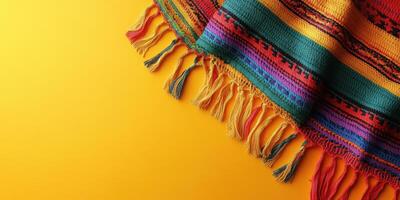 Colorful woven textile draped on a bright yellow surface showcasing intricate patterns and vibrant hues photo