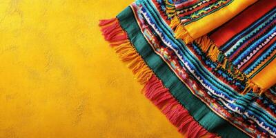 Colorful woven textiles displayed on a vibrant yellow surface showcasing intricate patterns and craftsmanship photo