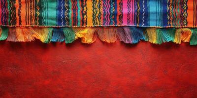 Vibrant textile with colorful fringes against a warm red backdrop creating an inviting atmosphere photo