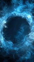 Swirling blue mist forms a captivating circular pattern against a dark background photo