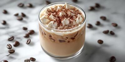Creamy iced coffee topped with whipped cream and cocoa sits on a marble surface with scattered coffee beans photo