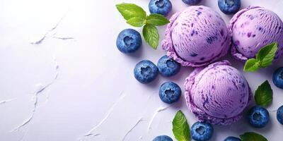 Delicious blueberry ice cream scoops surrounded by fresh blueberries and mint leaves on a light background photo