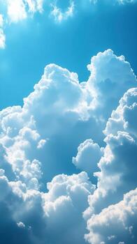 Beautiful fluffy white clouds against a bright blue sky during a sunny day creating a tranquil atmosphere photo