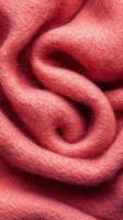 Textured pink fabric curls elegantly, creating a soft and inviting appearance perfect for cozy decor photo