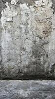 Textured wall with peeling paint in an urban setting during daylight hours photo