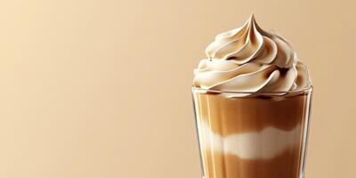 Delicious dessert coffee topped with creamy whipped cream and caramel swirl served in a clear glass photo
