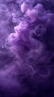 Colorful purple smoke swirling in a dark atmosphere creating an ethereal effect photo
