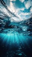 Underwater view showcasing sunlight filtering through wavy ocean surface and bubbles rising towards the light photo