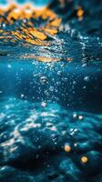 Bubbles rising in clear blue water on a sunny day, capturing the essence of underwater tranquility and beauty photo