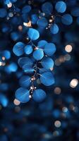 Bright blue leaves illuminated with soft lights during an evening in a lush garden photo