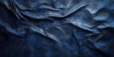 Detailed view of textured dark blue leather showcasing creases and natural patterns in a dramatic light photo
